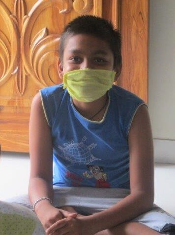 A student wears a face mask during a Compassionate Citizen lesson held at his teacher's home.