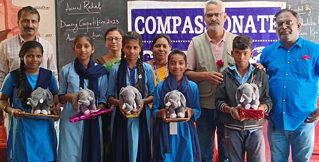 This image shows drawing contest winners posing with their prizes and Animal Rahat staff.