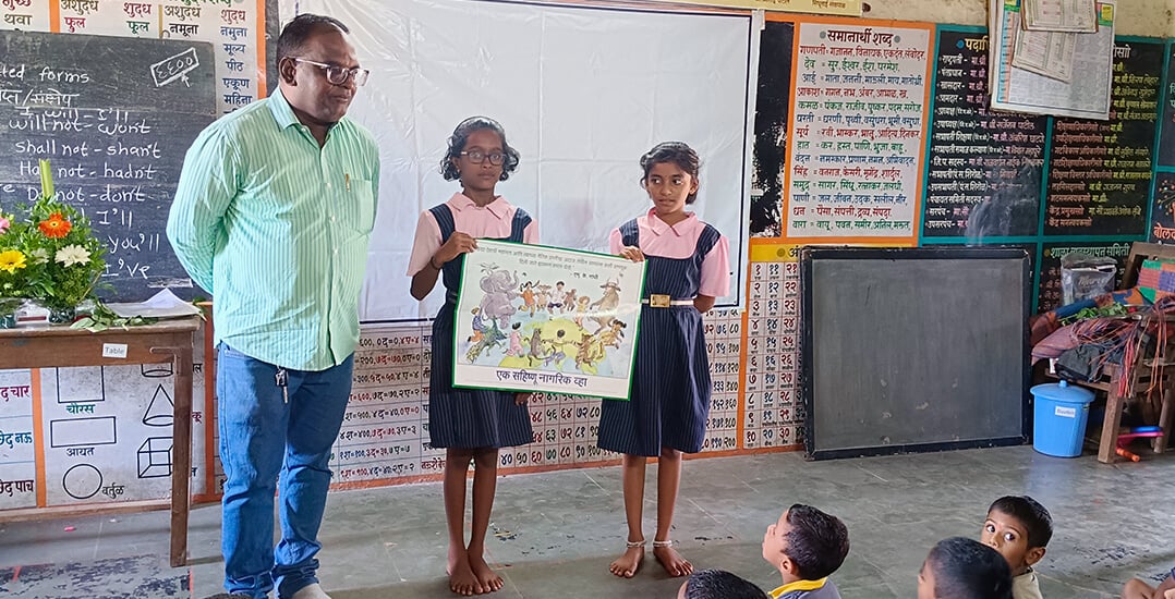 This image shows the Animal Rahat educational officer with two students.