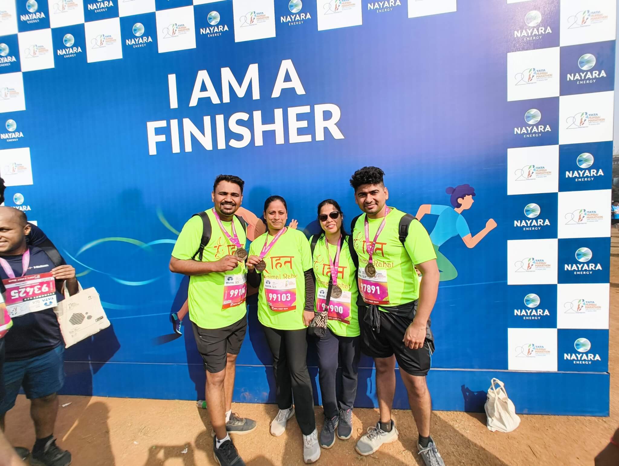 Runners Yogendra Nikam, Erika Goyal, Seema Raul, and Ritesh pose with their marathon medals.